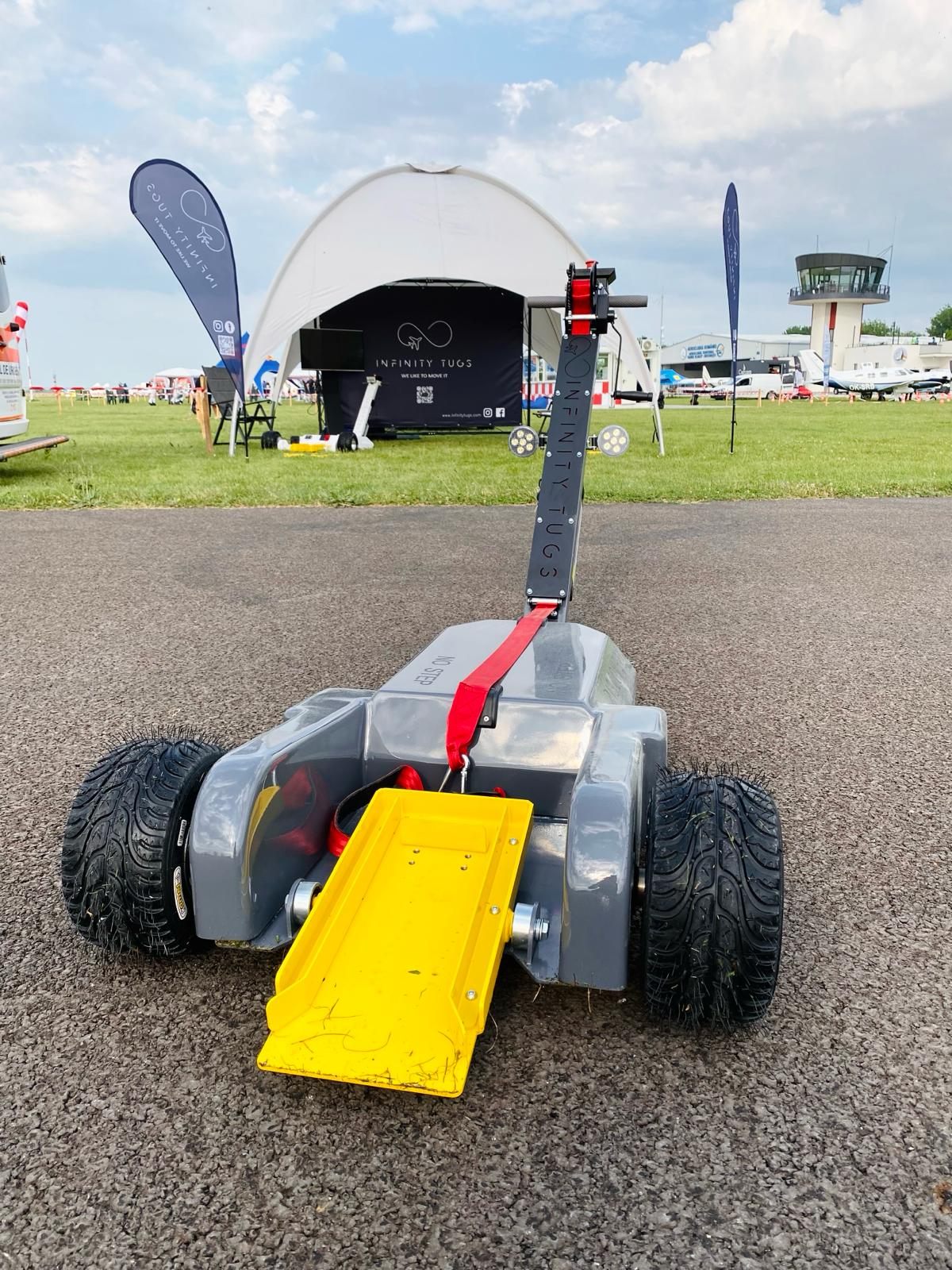 Infinity Tugs booth and products on display at an aviation trade show